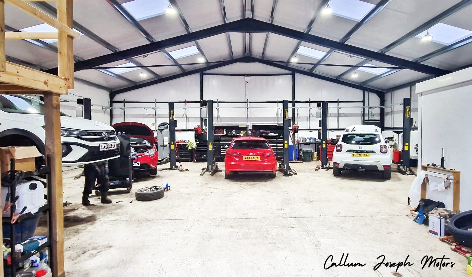 Inside the CF Motors workshop, with cars on vehicle lifts
